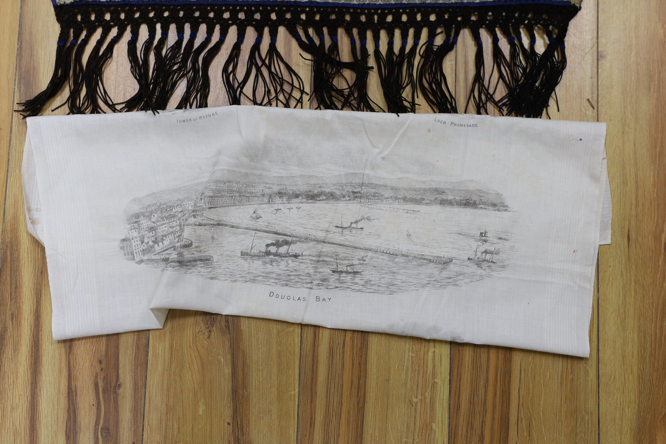 An early Victorian silk and velvet ladies stole, a length of finely woven silk with a woven check design and floral overprint, and a 19th century kerchief printed with scenes from the Isle of Man